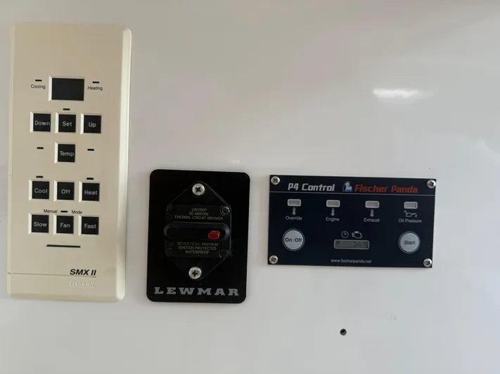 Club Car Yacht Photos Pics Control panels on a 1999 Cabo 31 Express boat, featuring SMX II, Lewmar, and Fischer Panda systems.