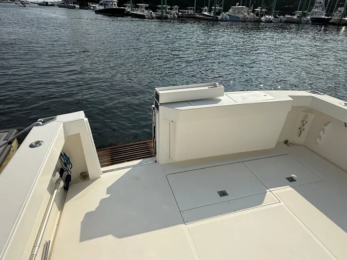 Club Car Yacht Photos Pics 1999 Cabo 31 Express boat deck overlooking marina with calm water.