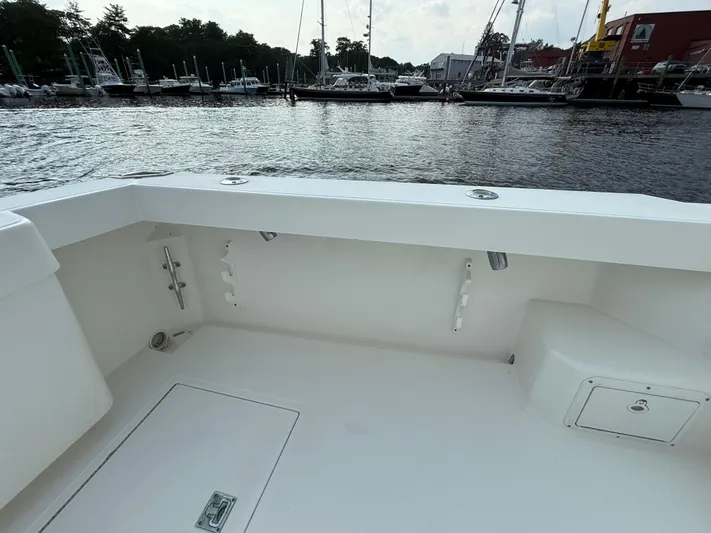 Club Car Yacht Photos Pics 1999 Cabo 31 Express boat deck with marina view in the background.