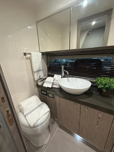  Yacht Photos Pics Luxurious bathroom in 2024 Sessa Marine C44 Cruiser with modern sink and elegant decor.