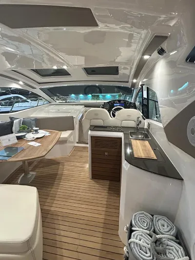  Yacht Photos Pics 2024 Sessa Marine C44 Cruiser interior with elegant seating, wooden flooring, and modern amenities.