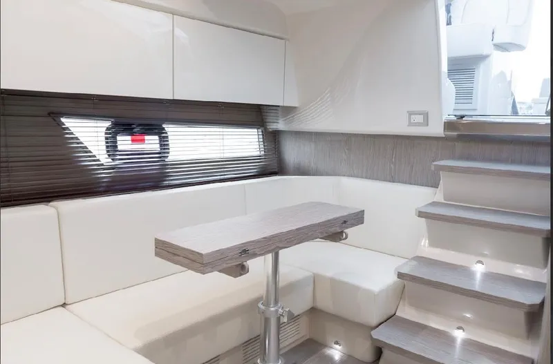  Yacht Photos Pics 2024 Sessa Marine C44 Cruiser interior with modern seating and wooden table.