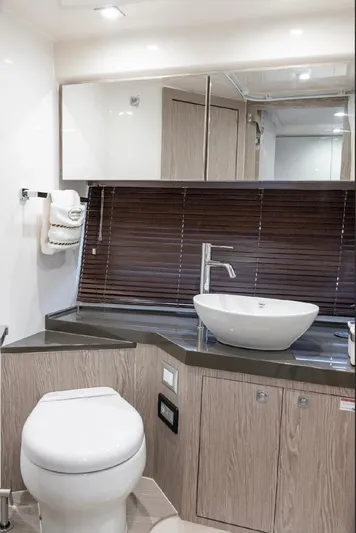  Yacht Photos Pics Luxurious bathroom interior of 2024 Sessa Marine C44 Cruiser with modern fixtures and wood accents.