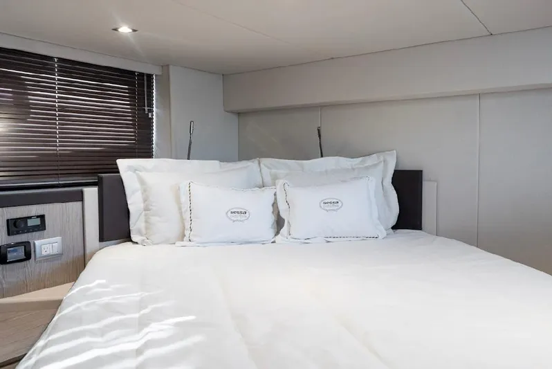  Yacht Photos Pics Luxurious bedroom interior of 2024 Sessa Marine C44 Cruiser with elegant bedding and modern design.