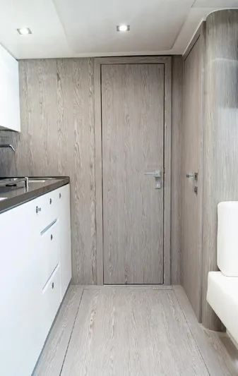  Yacht Photos Pics Interior of 2024 Sessa Marine C44 Cruiser, featuring modern wood paneling and sleek cabinetry.