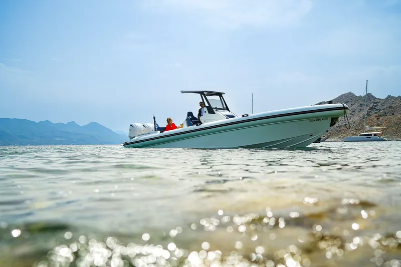 Rock Marine Rm 36 U | 36 S Yacht Photos Pics 2026 Rock Marine RM 36 boat cruising in clear waters near rocky coastline.