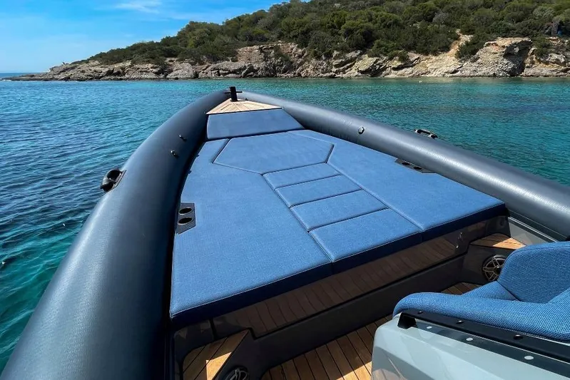 Rock Marine Rm 36 U | 36 S Yacht Photos Pics 2026 Rock Marine RM 36 boat on clear blue water near rocky coastline.