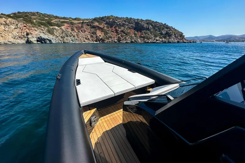 Rock Marine Rm 36 U | 36 S Yacht Photos Pics 2026 Rock Marine RM 36 boat cruising near rocky coastline under clear blue sky.