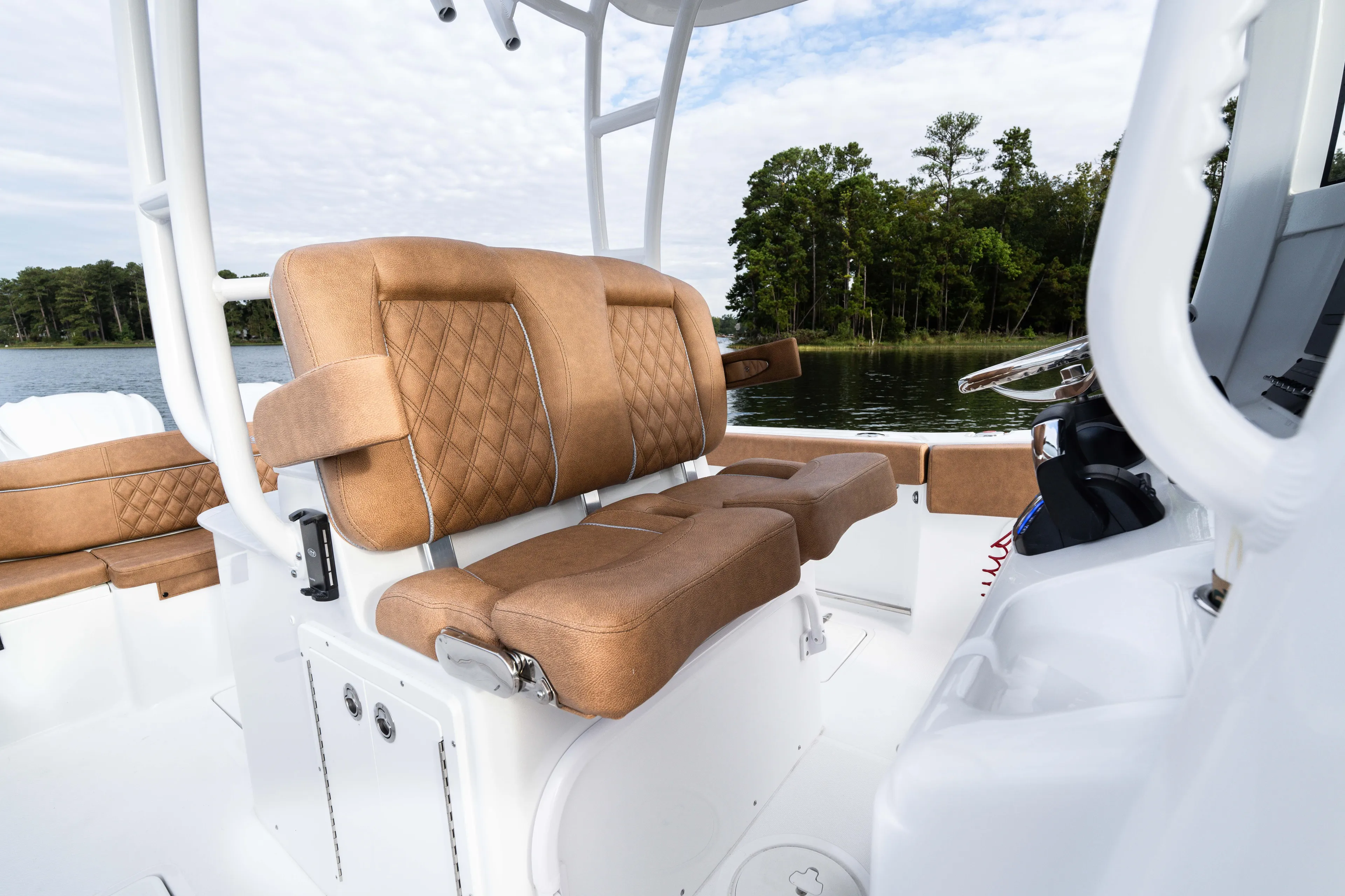  Yacht Photos Pics 2026 Sea Hunt Ultra 285 SE boat interior with tan cushioned seating and steering wheel.
