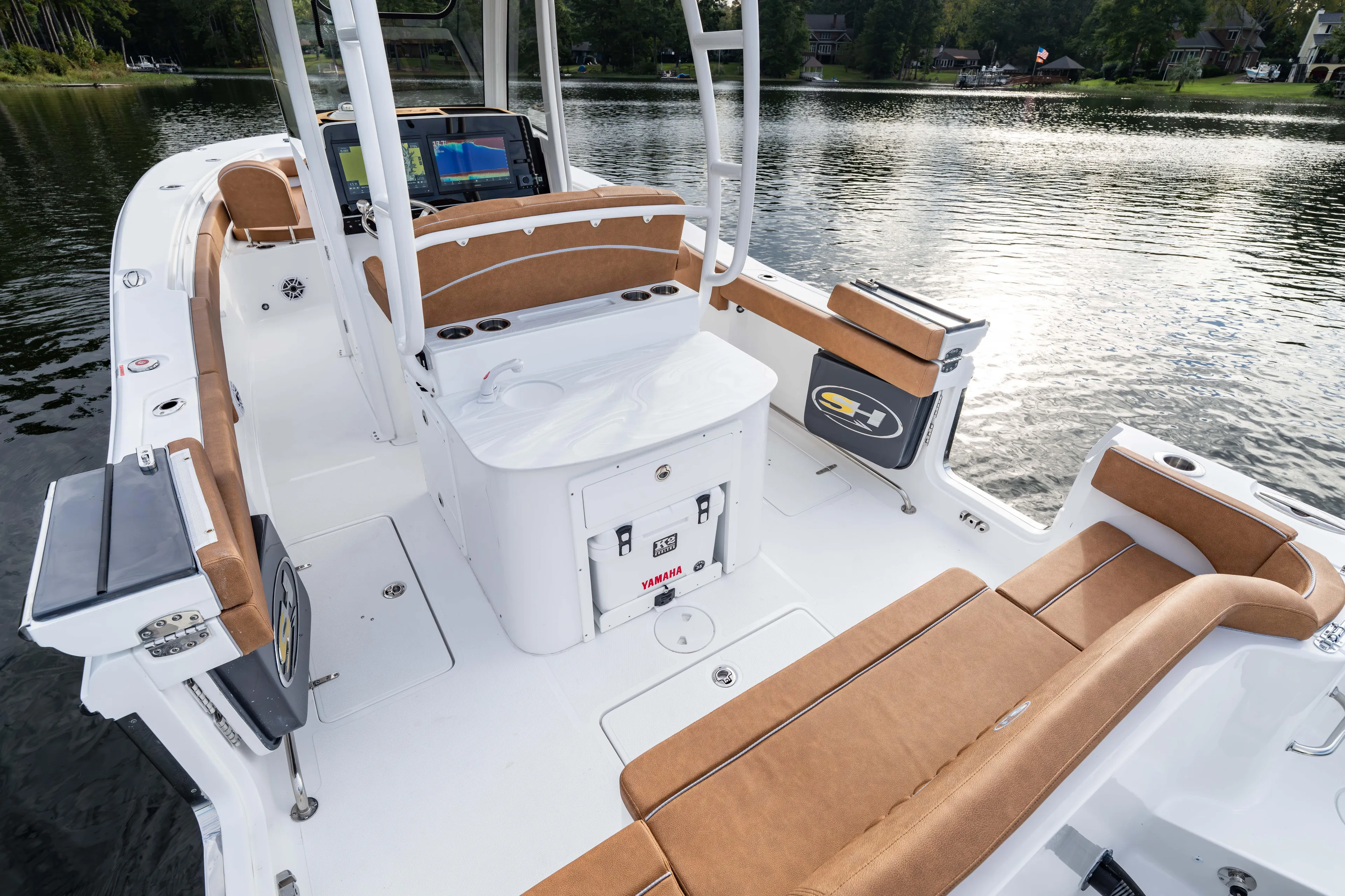  Yacht Photos Pics 2026 Sea Hunt Ultra 285 SE boat interior with tan seating on a serene lake.