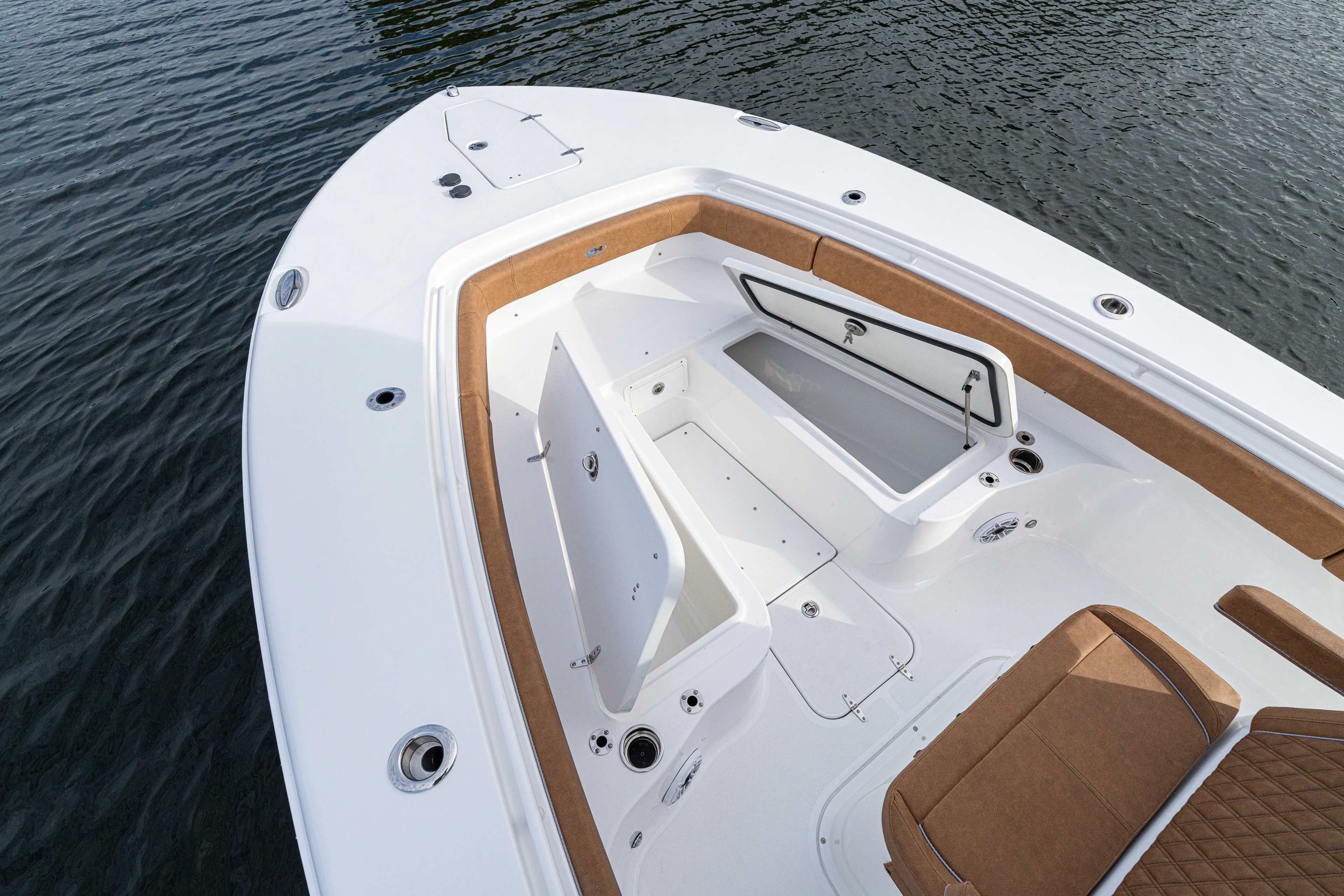  Yacht Photos Pics 2026 Sea Hunt Ultra 285 SE boat interior with open storage compartments on calm water.