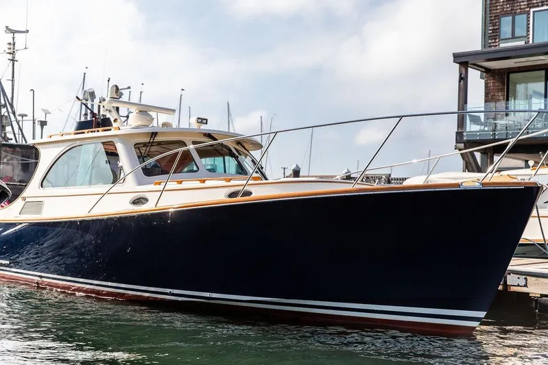 Swift Yacht Photos Pics 2005 Hinckley Talaria 40 yacht docked in a marina, showcasing sleek design and luxury.