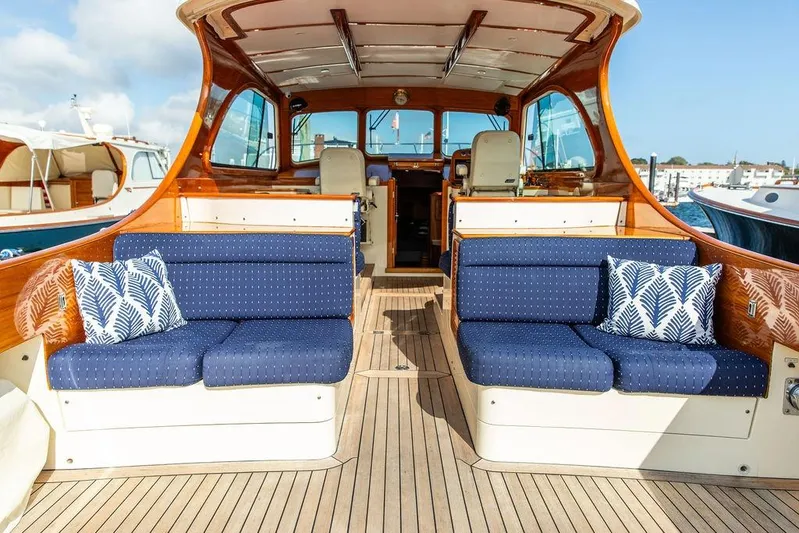 Swift Yacht Photos Pics Luxurious 2005 Hinckley Talaria 40 yacht interior with blue seating and nautical decor.