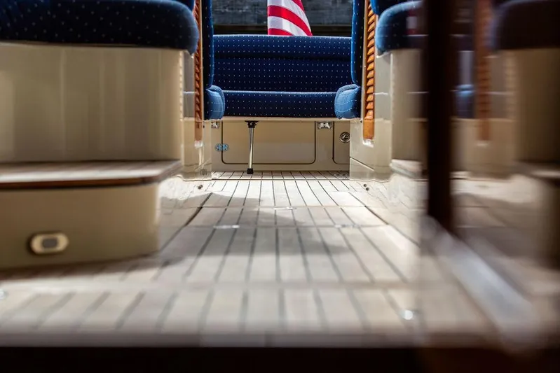 Swift Yacht Photos Pics Interior view of 2005 Hinckley Talaria 40 yacht with wooden flooring and blue seating.