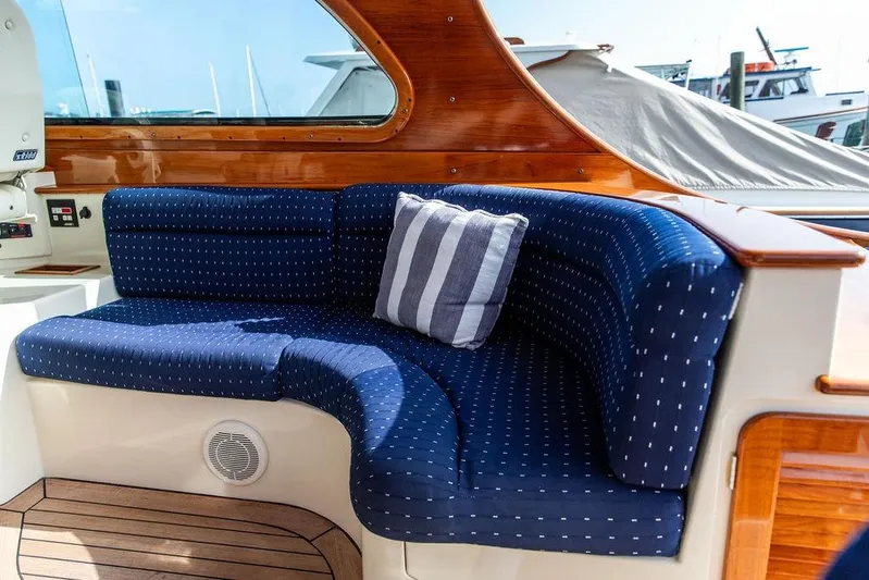 Swift Yacht Photos Pics Luxurious seating on 2005 Hinckley Talaria 40 yacht with blue cushions and striped pillow.