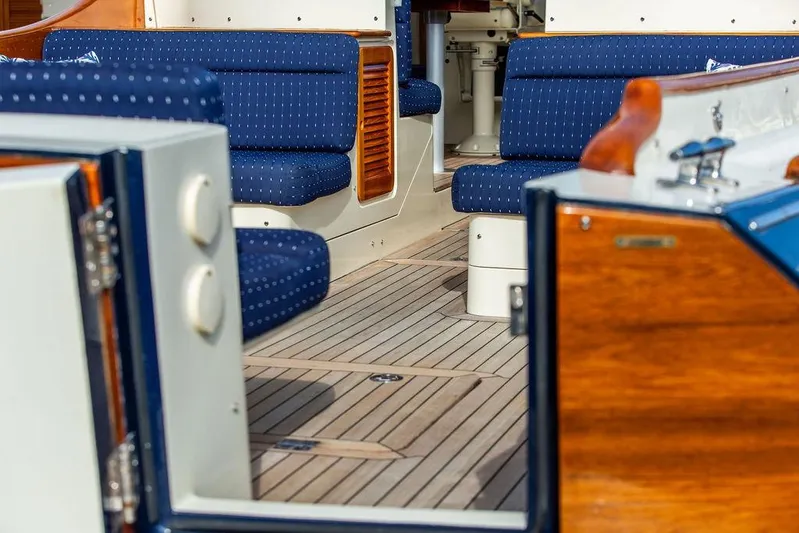 Swift Yacht Photos Pics Interior of 2005 Hinckley Talaria 40 yacht with blue seating and wooden accents.
