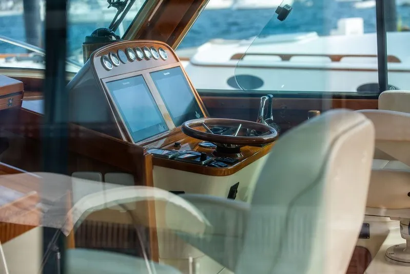 Swift Yacht Photos Pics Interior view of 2005 Hinckley Talaria 40 yacht cockpit with steering wheel and navigation screens.