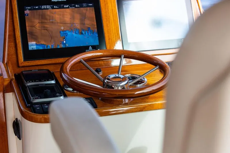 Swift Yacht Photos Pics Helm of 2005 Hinckley Talaria 40 with wooden steering wheel and navigation display.