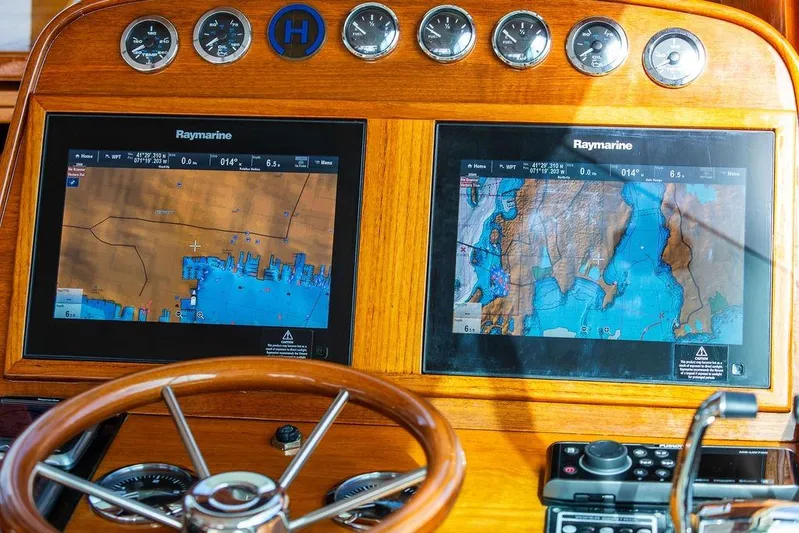 Swift Yacht Photos Pics 2005 Hinckley Talaria 40 dashboard with Raymarine navigation displays and wooden steering wheel.