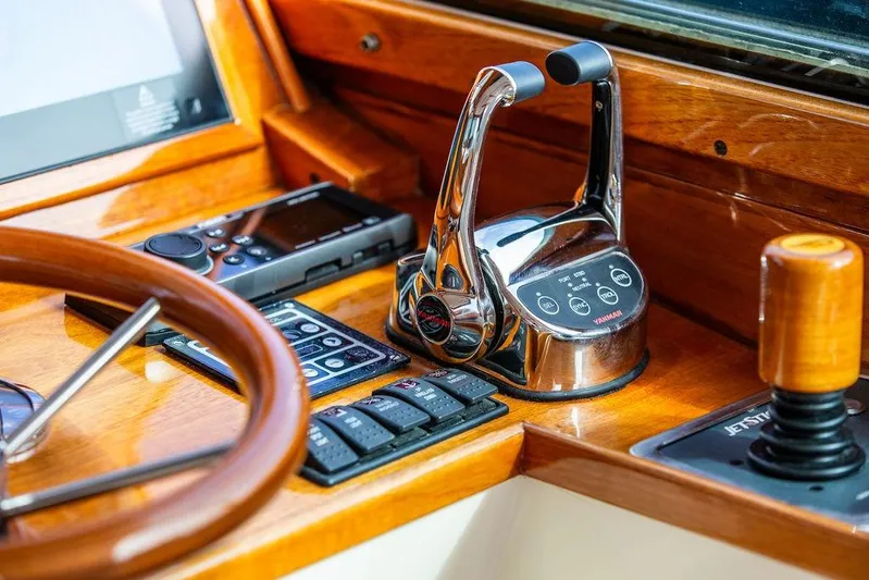 Swift Yacht Photos Pics Helm controls of a 2005 Hinckley Talaria 40, featuring polished wood and modern instruments.