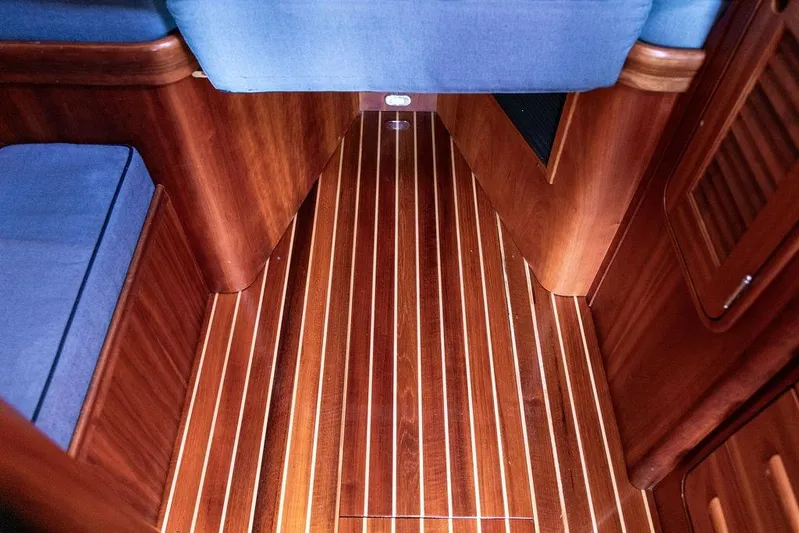 Swift Yacht Photos Pics Interior of 2005 Hinckley Talaria 40 yacht with polished wooden flooring and blue seating.