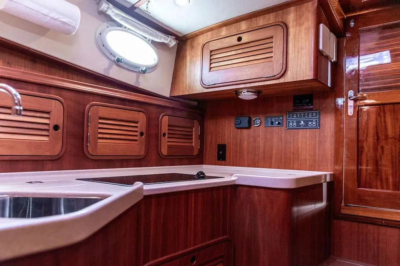 Swift Yacht Photos Pics 2005 Hinckley Talaria 40 yacht interior with wooden cabinetry and modern kitchen amenities.