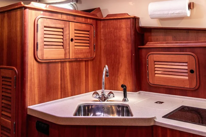 Swift Yacht Photos Pics Luxurious 2005 Hinckley Talaria 40 yacht interior with elegant wood cabinetry and modern sink.