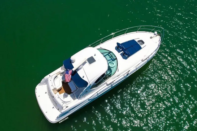  Yacht Photos Pics Aerial view of 2010 Sea Ray 390 Sundancer yacht on sparkling green water.
