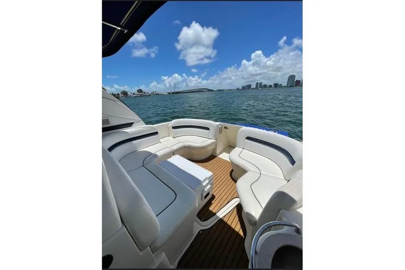  Yacht Photos Pics 2010 Sea Ray 390 Sundancer yacht interior with white seating, ocean view, and city skyline.