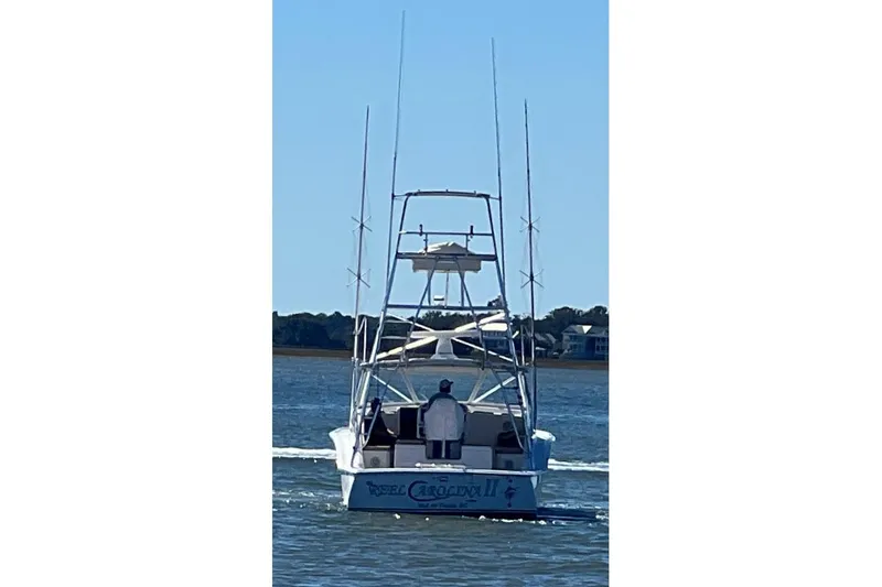 Reel Carolina II Yacht Photos Pics 2002 Out Island 38 Express Fisherman boat on water, rear view, clear sky.