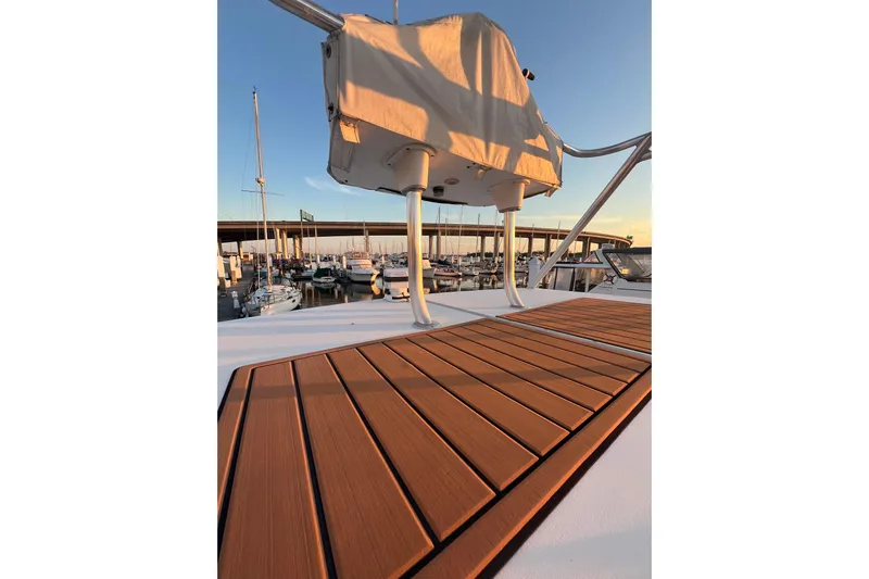 Reel Carolina II Yacht Photos Pics 2002 Out Island 38 Express Fisherman boat deck at sunset in marina.