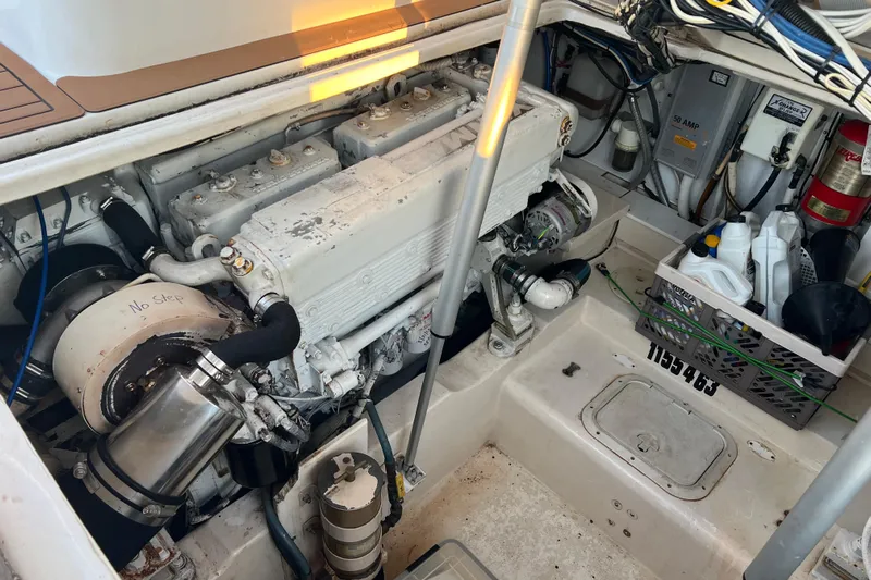 Reel Carolina II Yacht Photos Pics Engine compartment of a 2002 Out Island 38 Express Fisherman with maintenance supplies.