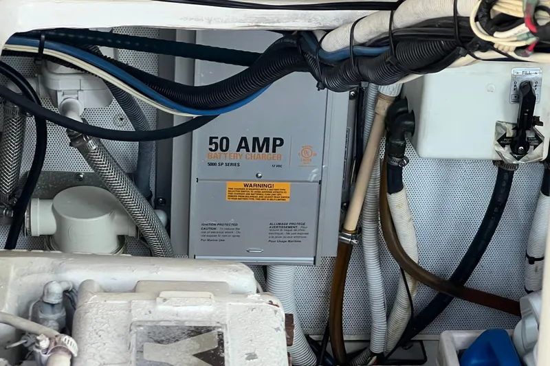 Reel Carolina II Yacht Photos Pics Engine compartment of 2002 Out Island 38 Express Fisherman with 50 AMP battery charger.