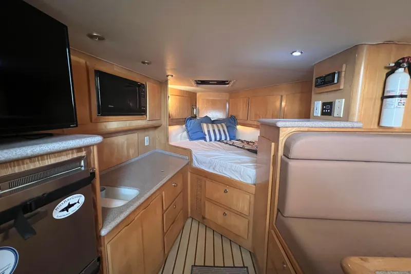 Reel Carolina II Yacht Photos Pics Interior of 2002 Out Island 38 Express Fisherman with cozy bed and modern amenities.