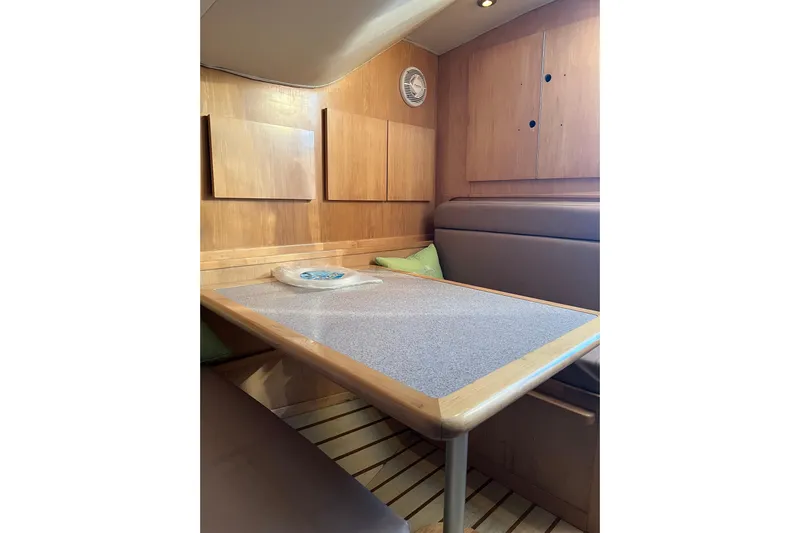 Reel Carolina II Yacht Photos Pics 2002 Out Island 38 Express Fisherman cabin interior with wooden table and seating.