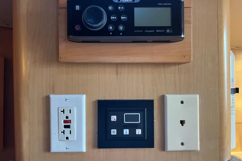 Reel Carolina II Yacht Photos Pics Control panel and outlets on 2002 Out Island 38 Express Fisherman boat interior.