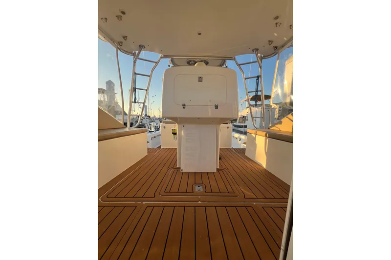 Reel Carolina II Yacht Photos Pics 2002 Out Island 38 Express Fisherman boat deck with wooden flooring and seating area.