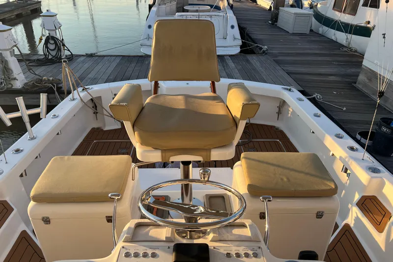 Reel Carolina II Yacht Photos Pics 2002 Out Island 38 Express Fisherman boat interior with helm and cushioned seating.