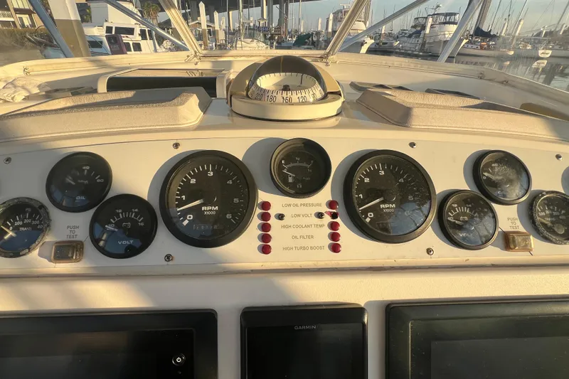 Reel Carolina II Yacht Photos Pics Dashboard of a 2002 Out Island 38 Express Fisherman boat with gauges and compass.
