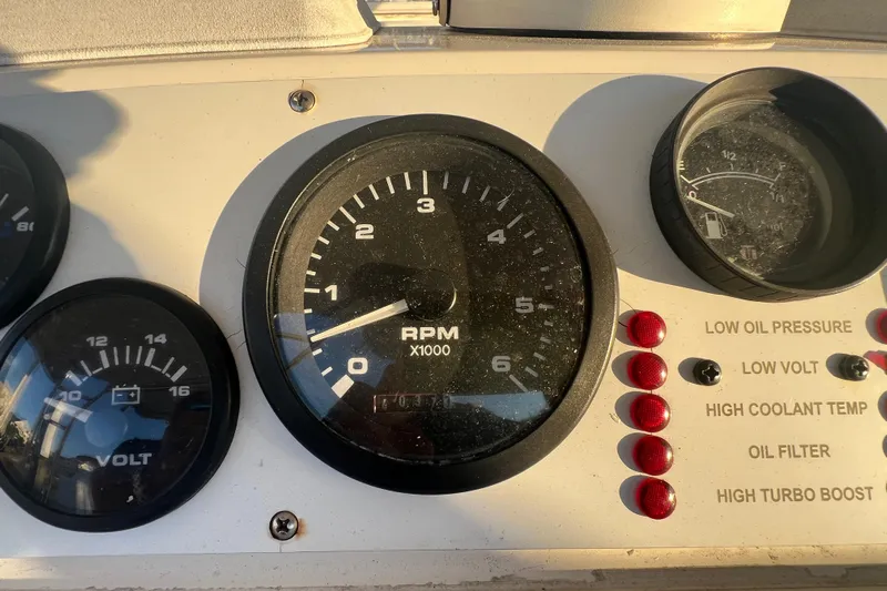Reel Carolina II Yacht Photos Pics Instrument panel of a 2002 Out Island 38 Express Fisherman boat, showing RPM and voltage gauges.