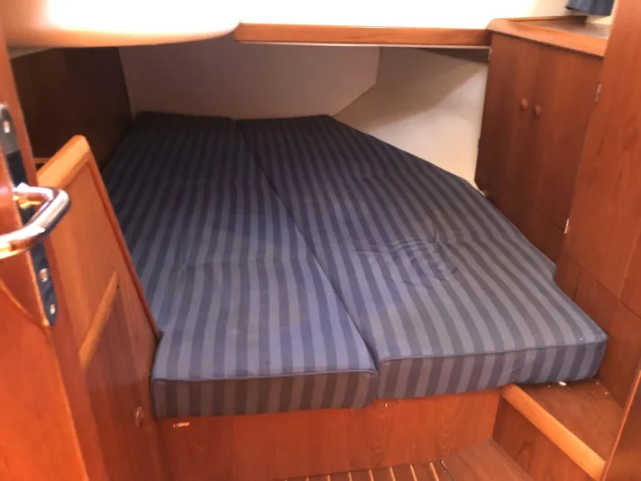 Ozymandias Yacht Photos Pics Cozy cabin interior of 2001 Jeanneau 45.2 sailboat with striped bedding.