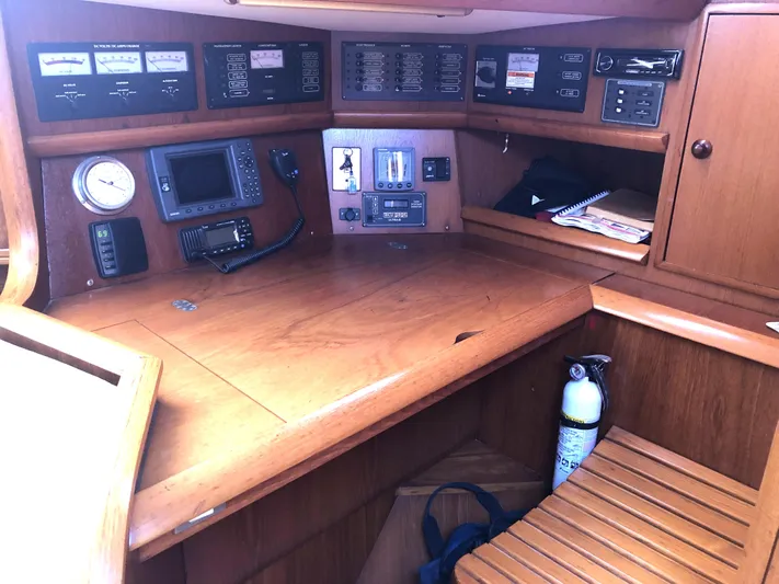Ozymandias Yacht Photos Pics Navigation station of a 2001 Jeanneau 45.2 sailboat with control panels and equipment.