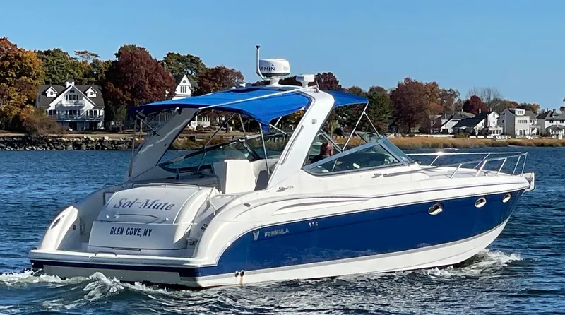 Sol Mate Yacht Photos Pics 2003 Formula 370 SS boat cruising on water with scenic shoreline background.