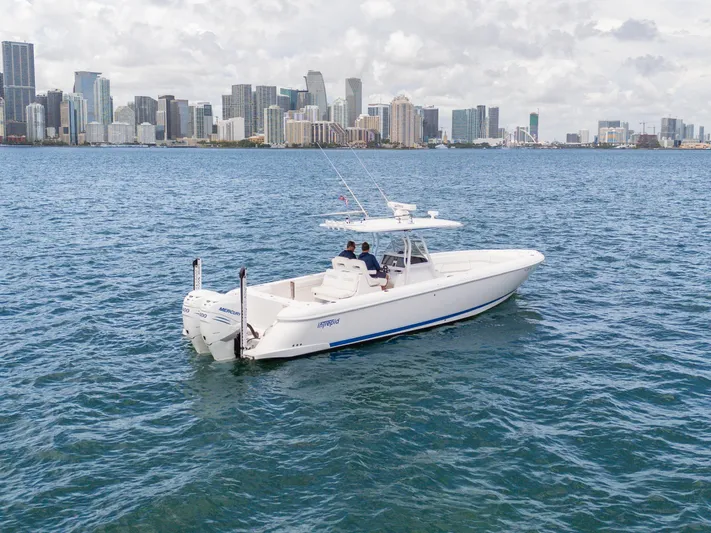  Yacht Photos Pics 2021 Intrepid 345 Nomad FE boat cruising near city skyline.