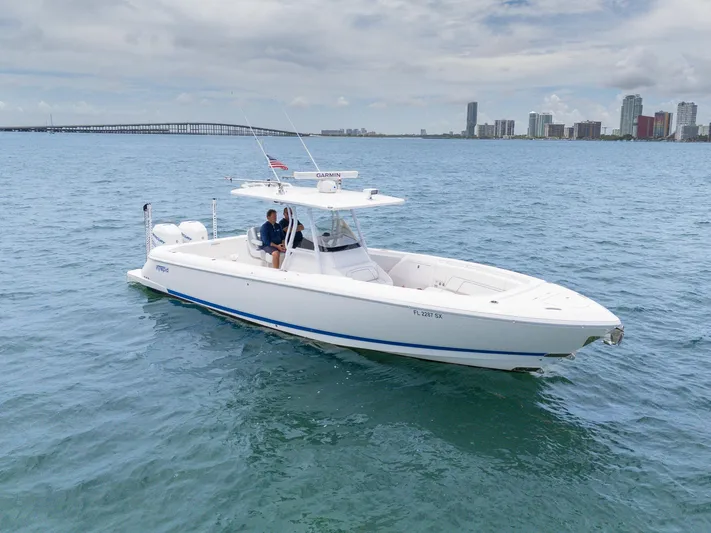  Yacht Photos Pics 2021 Intrepid 345 Nomad FE boat cruising near city skyline.