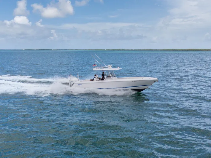  Yacht Photos Pics 2021 Intrepid 345 Nomad FE cruising on open water under a clear sky.