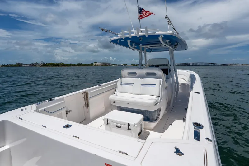  Yacht Photos Pics 2021 Intrepid 345 Nomad FE boat on water, featuring sleek design and American flag.