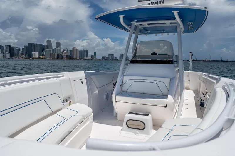  Yacht Photos Pics 2021 Intrepid 345 Nomad FE boat with city skyline in the background.