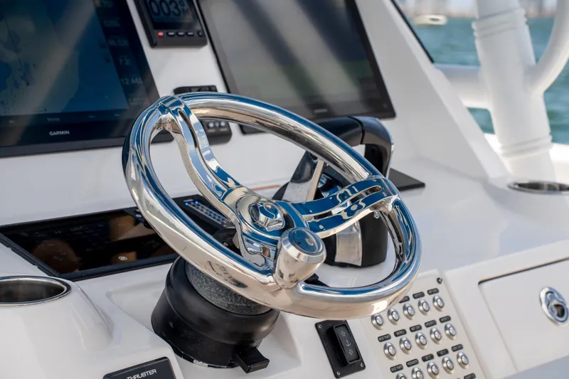  Yacht Photos Pics Steering wheel of 2021 Intrepid 345 Nomad FE boat with navigation screens.