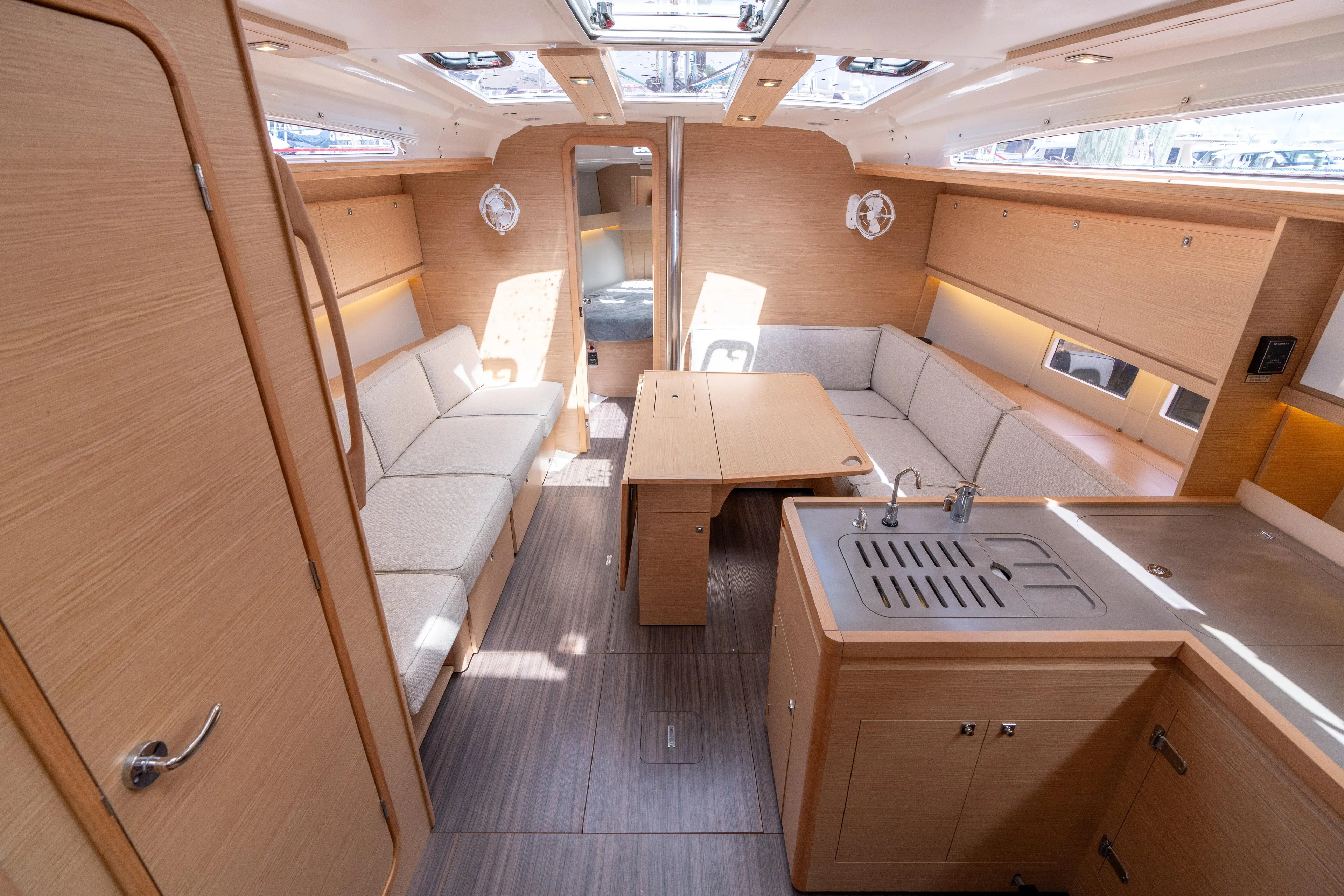 Lunar Sea Yacht Photos Pics Modern interior of 2023 Dufour 390 yacht with spacious seating and kitchen area.